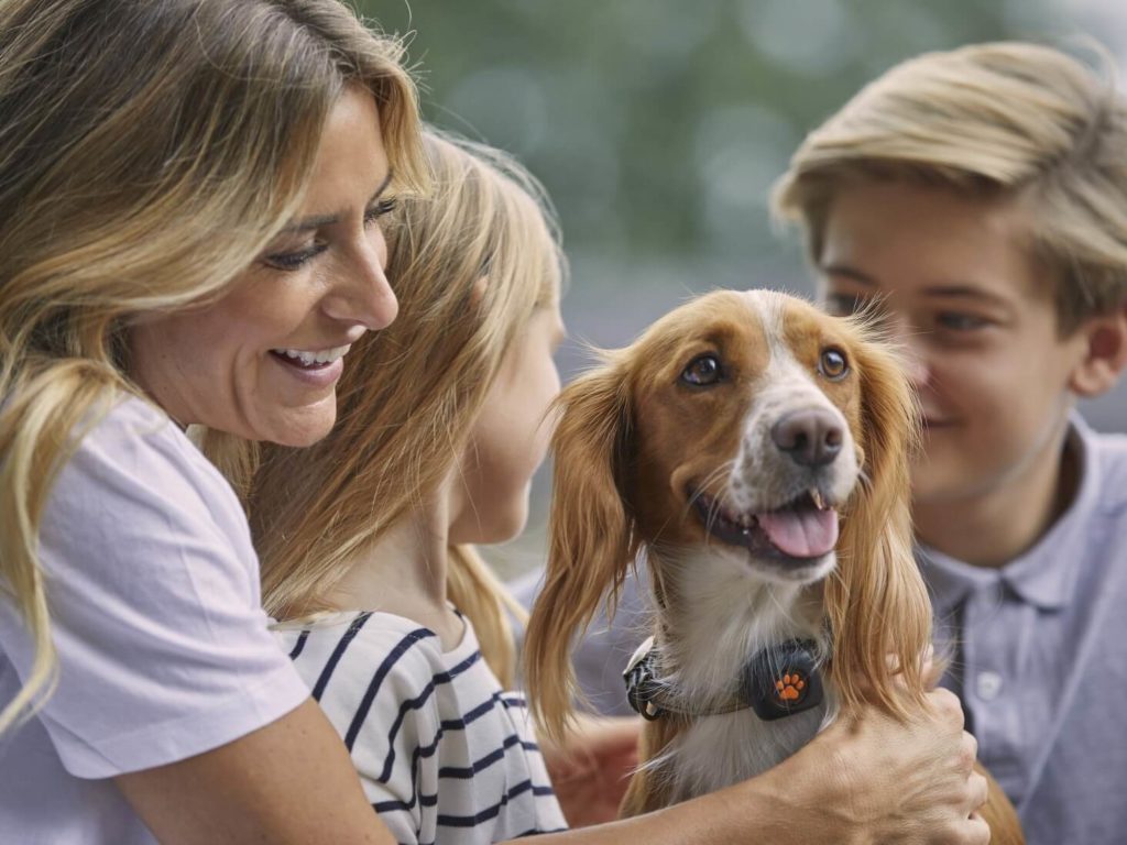 Family hugging a dog