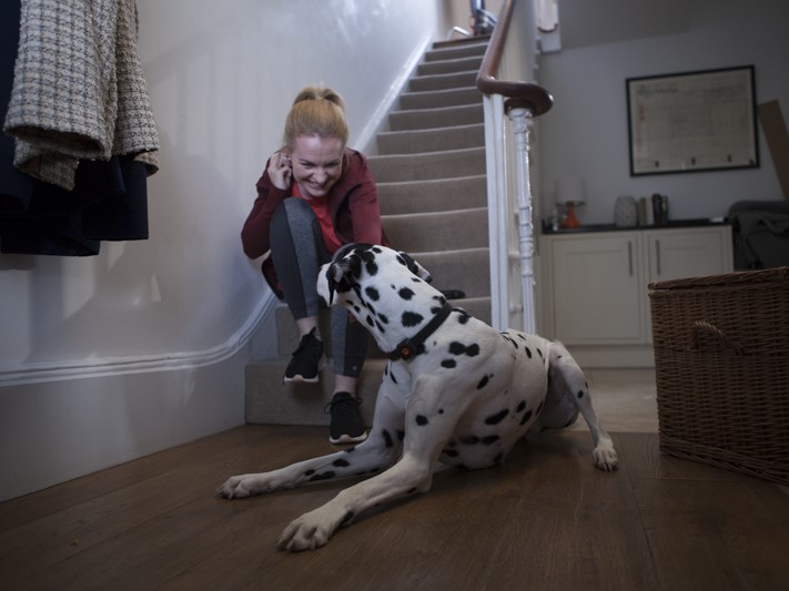 Woman with dalmatian on stairs