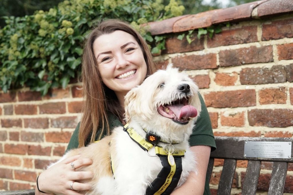 Woman with dog wearing Dogs Trust Harness and PitPat