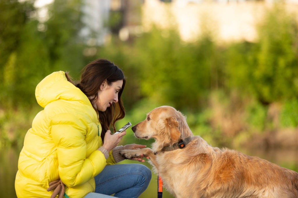 Woman sitting with golden retriever