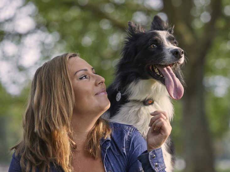 Lady sat outside with collie