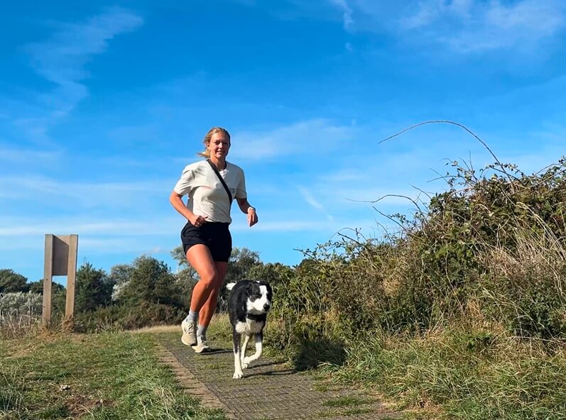Female runner, Megan Boxall, with a Border Collie, Shadow.